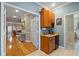 Breakfast bar with a sink and a mini refrigerator, as well as access to the hallway and bathroom at 830 Pinellas Bayway S, St Petersburg, FL 33715