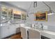 Stylish dining area showcases elegant cabinetry, decorative dishware, and reflective mirrored backsplash at 830 Pinellas Bayway S, St Petersburg, FL 33715