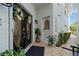 A welcoming home entrance features elegant double doors, a decorative glass window, and lush landscaping at 830 Pinellas Bayway S, St Petersburg, FL 33715
