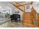 Grand foyer with a staircase, marble floors, and a stylish piano, creating an inviting entrance at 830 Pinellas Bayway S, St Petersburg, FL 33715