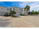 The front of the home offers a spacious driveway and a well-manicured lawn at 830 Pinellas Bayway S, St Petersburg, FL 33715