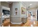 Hallway leading to a bedroom and the main bedroom, with a small table and decorative painting at 830 Pinellas Bayway S, St Petersburg, FL 33715