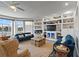 Inviting living room featuring cozy sofas, a built-in display cabinet, and serene waterfront views at 830 Pinellas Bayway S, St Petersburg, FL 33715