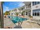 A private outdoor pool at a white building, complete with a patio for relaxation and palm trees at 830 Pinellas Bayway S, St Petersburg, FL 33715