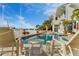 A community pool with patio furniture and well-kept landscaping at 830 Pinellas Bayway S, St Petersburg, FL 33715