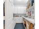 Well-lit room with built-in shelves and ample storage space, perfect for a home office or craft room at 830 Pinellas Bayway S, St Petersburg, FL 33715