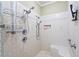The shower in the bathroom features dual shower heads, built-in seat and storage niche at 830 Pinellas Bayway S, St Petersburg, FL 33715
