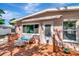 Inviting back porch featuring a awning, white wicker furniture, and a wooden deck at 940 43Rd Ne Ave, St Petersburg, FL 33703