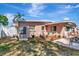 Exterior view of the home showcasing a well-maintained lawn, landscaping, and outdoor living space at 940 43Rd Ne Ave, St Petersburg, FL 33703