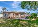 Backyard with a patio, landscaping, and comfortable seating, creating an inviting outdoor living space next to the home at 940 43Rd Ne Ave, St Petersburg, FL 33703
