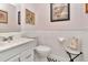 Clean half-bathroom featuring a vanity with a sink, toilet, and stylish checkered flooring at 940 43Rd Ne Ave, St Petersburg, FL 33703