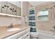 Clean bathroom featuring a single vanity, shower, and tub combination with blue and green curtain at 940 43Rd Ne Ave, St Petersburg, FL 33703