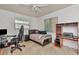 Neutral bedroom features a comfortable bed, computer desk, and ample natural light at 940 43Rd Ne Ave, St Petersburg, FL 33703