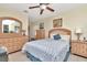 Comfortable bedroom featuring a light wood bedroom set, ceiling fan and a cozy blue floral bedding at 940 43Rd Ne Ave, St Petersburg, FL 33703
