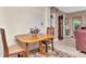 Cozy dining area featuring a wood table, comfortable chairs, and a view of the living area at 940 43Rd Ne Ave, St Petersburg, FL 33703