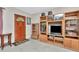 Inviting entryway featuring a wood door, neutral tile floors, and a large wooden media center at 940 43Rd Ne Ave, St Petersburg, FL 33703