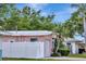 Side angle of house with white fence, garage, and lovely green landscaping at 940 43Rd Ne Ave, St Petersburg, FL 33703