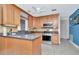 Bright kitchen featuring stainless steel appliances, wood cabinets, an island, and ample counter space at 940 43Rd Ne Ave, St Petersburg, FL 33703