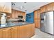 Well-lit kitchen boasts stainless steel appliances, island, and light wood cabinets at 940 43Rd Ne Ave, St Petersburg, FL 33703