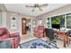 Spacious living room boasts a comfortable armchair, tiled flooring, and a wooden grandfather clock at 940 43Rd Ne Ave, St Petersburg, FL 33703