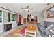 Spacious living room featuring tile floors, media center, gray sofa, and abundant natural light at 940 43Rd Ne Ave, St Petersburg, FL 33703