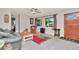 Cozy living room with tile flooring, gray sofa, wood burning stove and natural light at 940 43Rd Ne Ave, St Petersburg, FL 33703