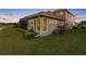 Landscaped backyard with lush greenery and screened-in patio, creating a private outdoor retreat at 9897 Sago Point Dr, Seminole, FL 33777