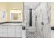 This bright bathroom showcases a marble vanity, white cabinets and a glass enclosed shower that adds to the luxurious design at 9897 Sago Point Dr, Seminole, FL 33777