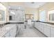 Bright, modern bathroom features marble countertops, white cabinetry, and a glass-enclosed shower, designed for a luxurious experience at 9897 Sago Point Dr, Seminole, FL 33777