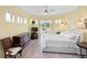Bright bedroom with hardwood floors, ceiling fan, and patio access, providing serene relaxation with ample natural light at 9897 Sago Point Dr, Seminole, FL 33777