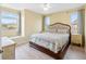 Comfortable bedroom featuring a cushioned headboard and bright windows at 9897 Sago Point Dr, Seminole, FL 33777