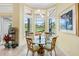 Cozy breakfast nook with floor-to-ceiling windows overlooking a beautiful lake view at 9897 Sago Point Dr, Seminole, FL 33777