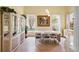 Elegant dining room with natural light and white wood table and chairs at 9897 Sago Point Dr, Seminole, FL 33777