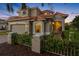 Charming two-story home with a well-maintained lawn, decorative fence, and attached two-car garage at 9897 Sago Point Dr, Seminole, FL 33777