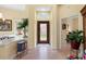 Bright foyer featuring a patterned glass door, high ceilings and wood floors at 9897 Sago Point Dr, Seminole, FL 33777