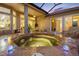 Inviting screened lanai featuring a private hot tub and seamless access to indoor living spaces at 9897 Sago Point Dr, Seminole, FL 33777