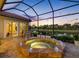 Covered patio with hot tub overlooking the water for relaxing evenings and picturesque views at 9897 Sago Point Dr, Seminole, FL 33777