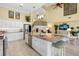 Open concept kitchen featuring an expansive island with seating and stainless steel appliances at 9897 Sago Point Dr, Seminole, FL 33777