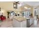 Modern kitchen featuring a large island with a sink and stainless steel dishwasher at 9897 Sago Point Dr, Seminole, FL 33777