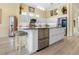 A lovely kitchen with a center island featuring a stainless steel dishwasher and white cabinets at 9897 Sago Point Dr, Seminole, FL 33777
