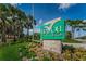 Community sign for Bayou Club, framed by lush landscaping and palm trees, welcomes residents and guests at 9897 Sago Point Dr, Seminole, FL 33777