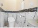 Modern toilet area with white marble accents and honeycomb tile trim that adds character to this well designed space at 9897 Sago Point Dr, Seminole, FL 33777