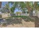 Spacious backyard with mature trees and a privacy fence at 10524 White Peacock Pl, Riverview, FL 33578