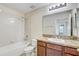 Well-lit bathroom with a vanity, tub, shower, and neutral tile at 10524 White Peacock Pl, Riverview, FL 33578