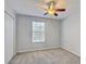 Cozy bedroom with carpet, a ceiling fan, and a window with blinds for privacy at 10524 White Peacock Pl, Riverview, FL 33578