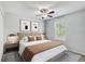 Inviting bedroom with neutral colors, a ceiling fan, a window with natural light, and stylish decor at 10524 White Peacock Pl, Riverview, FL 33578