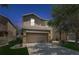 Charming two-story home featuring a two-car garage, landscaped yard, and elegant architectural details at 10524 White Peacock Pl, Riverview, FL 33578