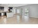 Open concept kitchen features stainless steel appliances, tile flooring, island and sliding glass door at 10524 White Peacock Pl, Riverview, FL 33578