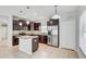 Kitchen with stainless steel appliances, granite counters, island, and tile flooring at 10524 White Peacock Pl, Riverview, FL 33578