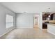 Open concept living room has neutral paint, tile flooring, and modern light fixtures at 10524 White Peacock Pl, Riverview, FL 33578
